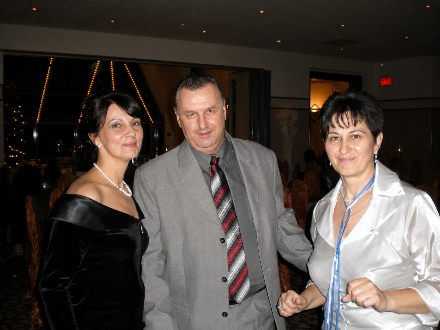 A real photo of three people at a celebration